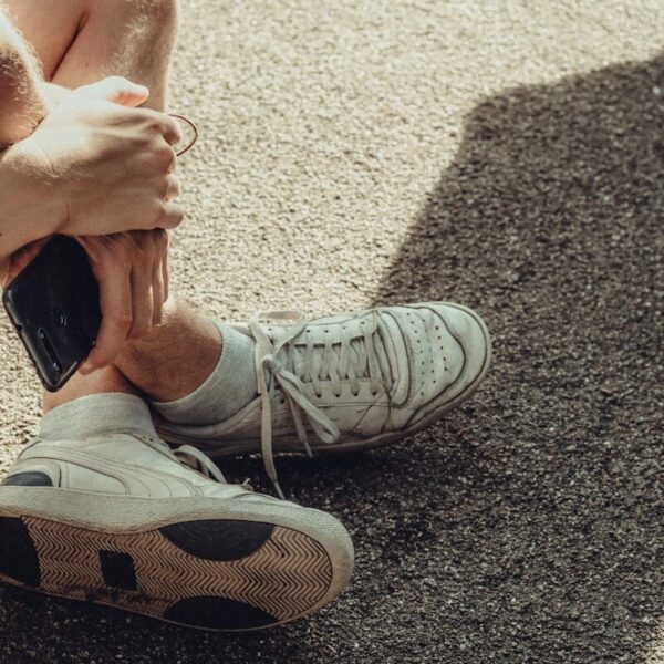 person wearing white nike sneakers