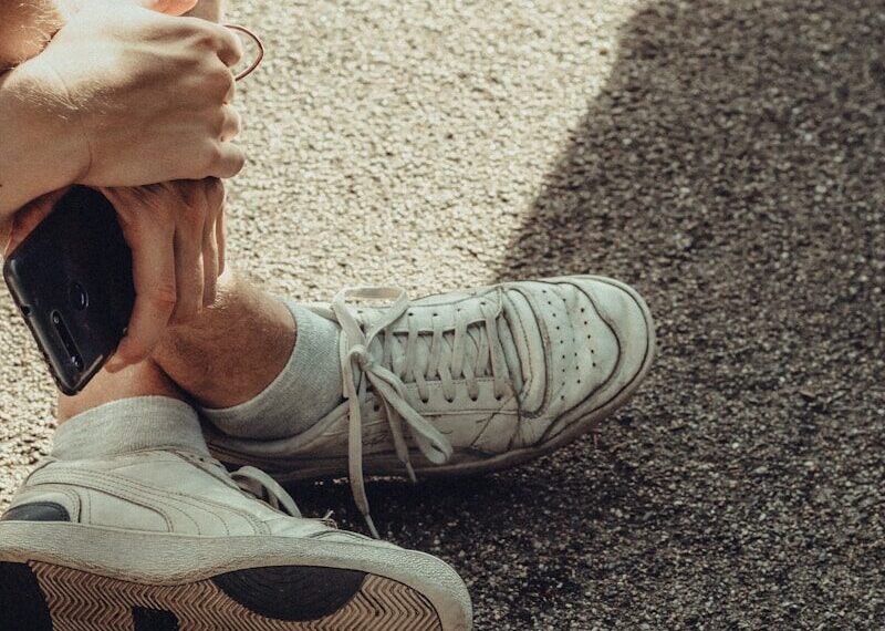 person wearing white nike sneakers